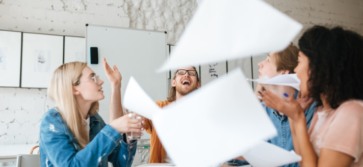 portrait-emotional-people-happily-throw-up-papers-office-while-working-together-group-young-students-joyfully-studying-with-books-table-classroom Large.jpeg