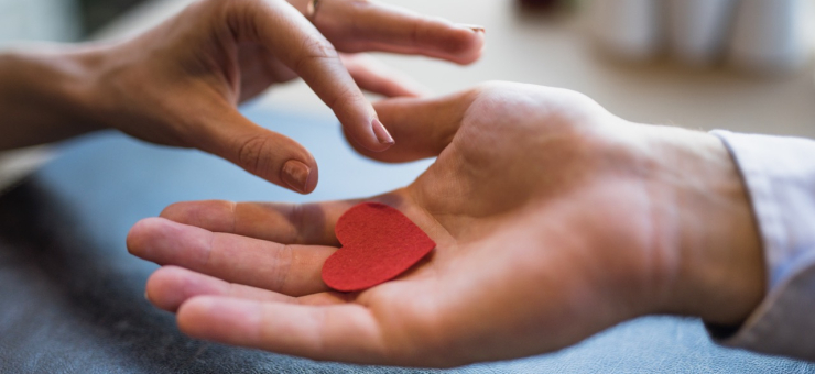 man-giving-red-ornament-heart-woman Large.jpeg